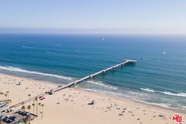 drone / aerial view with a water view and a beach view