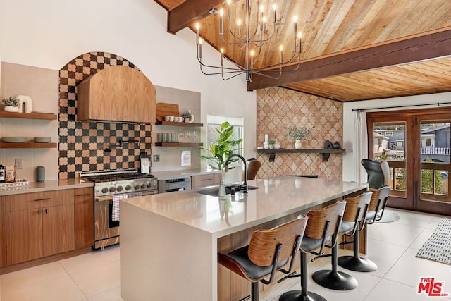 kitchen with high end stainless steel range oven, beam ceiling, sink, and light tile patterned floors