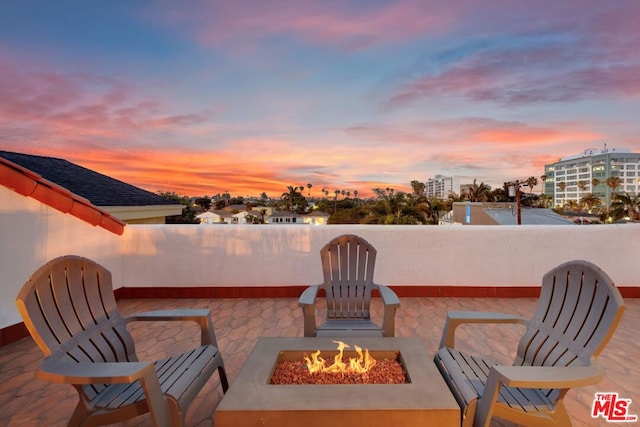 patio terrace at dusk with an outdoor fire pit