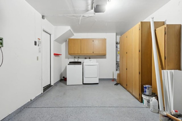 laundry room featuring cabinets and washing machine and clothes dryer