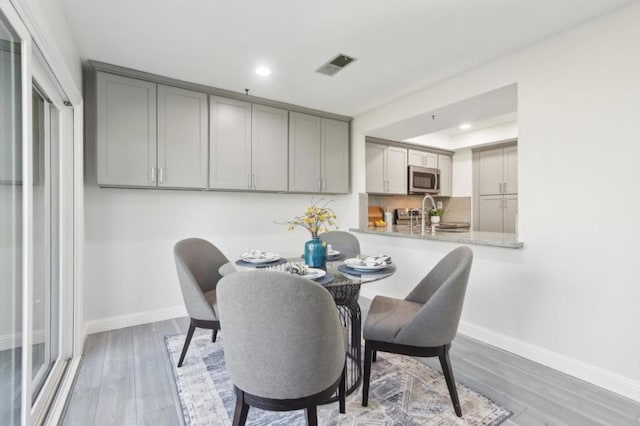 dining room with hardwood / wood-style flooring