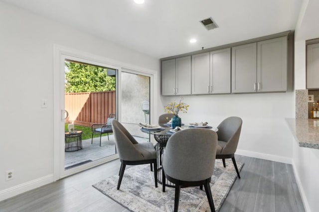 dining space with hardwood / wood-style floors