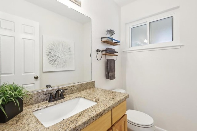 bathroom with vanity and toilet