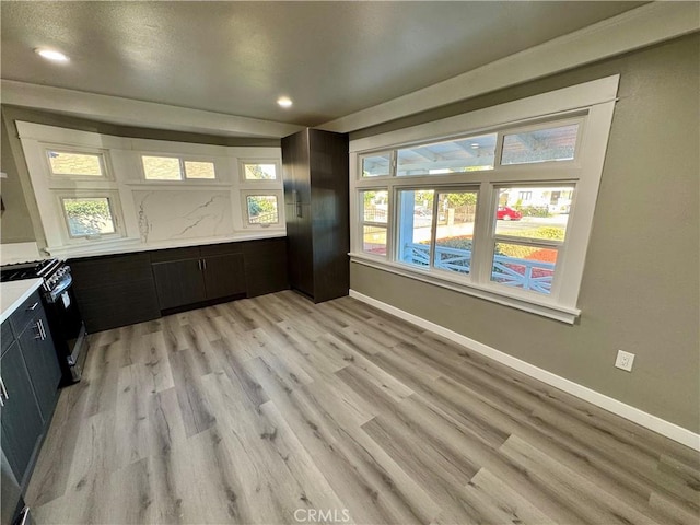 interior space with gas range oven and light wood-type flooring