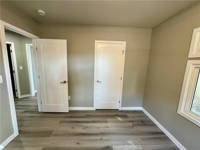 unfurnished bedroom featuring light wood-type flooring