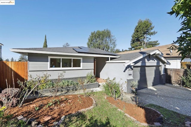 ranch-style house featuring solar panels