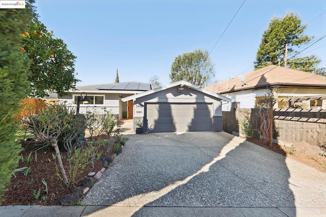 view of front of home featuring a garage and solar panels