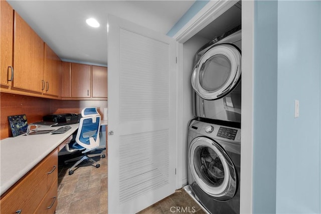 laundry area with stacked washing maching and dryer