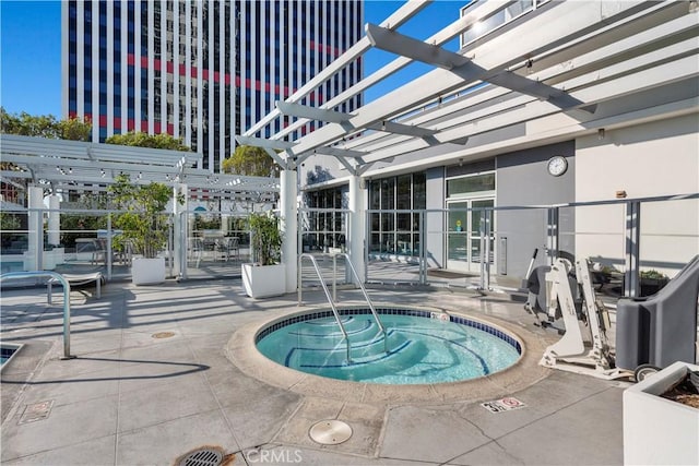 view of swimming pool featuring a hot tub, a patio area, and a pergola