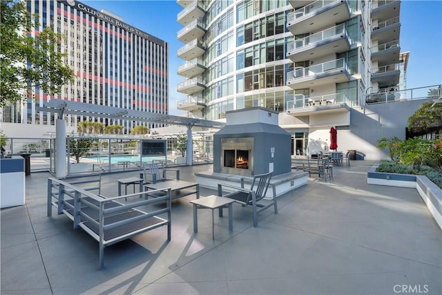 view of patio featuring exterior fireplace