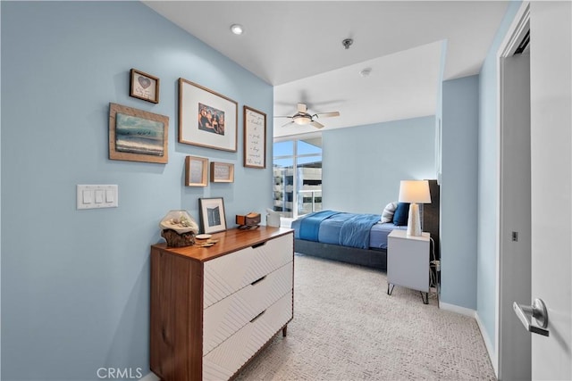 bedroom featuring light colored carpet and ceiling fan