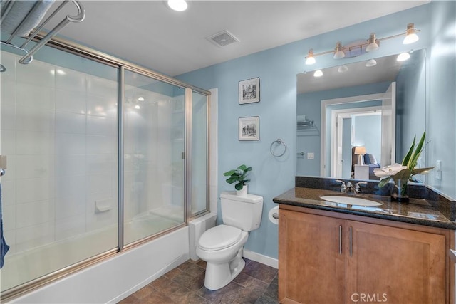 full bathroom featuring bath / shower combo with glass door, vanity, and toilet