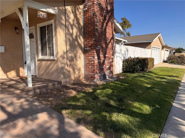 view of side of home with a garage and a lawn