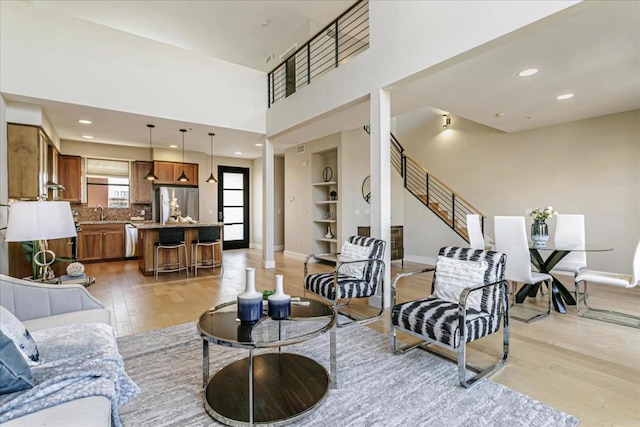 living room featuring light hardwood / wood-style flooring and built in features