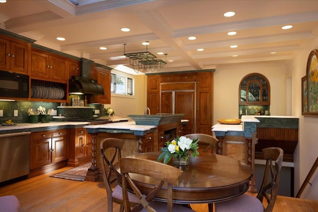 kitchen featuring dishwasher, black microwave, a center island, light hardwood / wood-style floors, and beamed ceiling