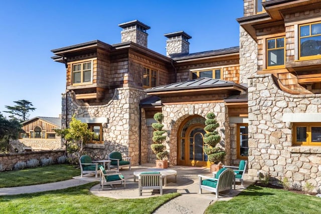 rear view of property with a patio area and a lawn