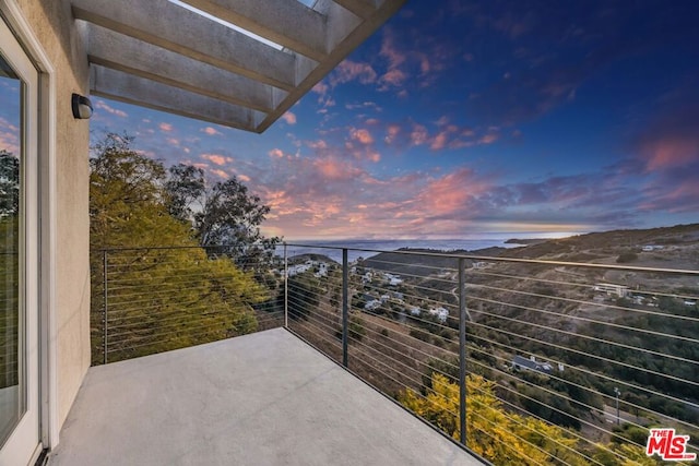 view of balcony at dusk