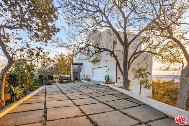 property exterior at dusk with a garage