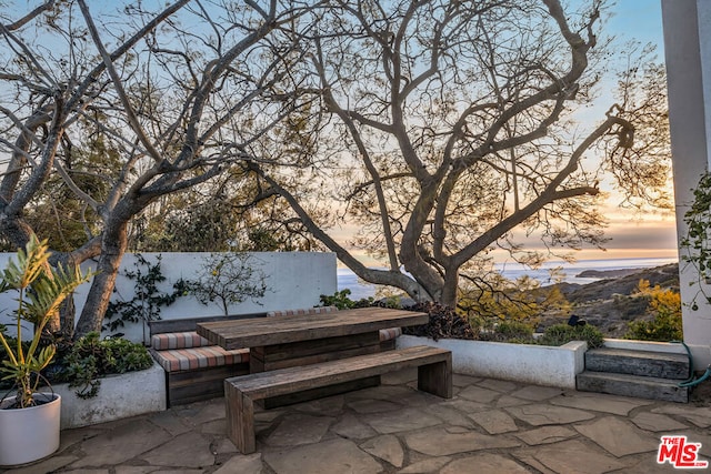 view of patio terrace at dusk