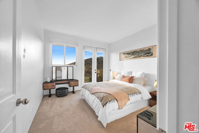 bedroom with light carpet, access to outside, and french doors