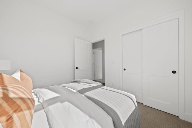 carpeted bedroom with a closet