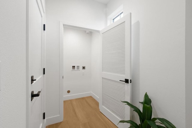 washroom with washer hookup, light hardwood / wood-style floors, and electric dryer hookup