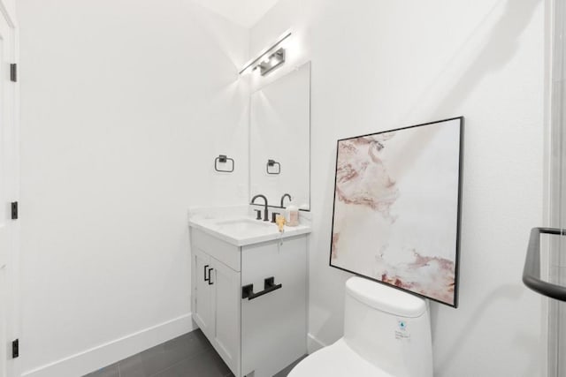 bathroom with vanity, tile patterned flooring, and toilet