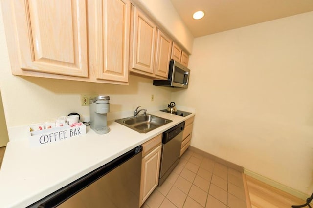 kitchen featuring sink, light tile patterned floors, stainless steel appliances, and light brown cabinets