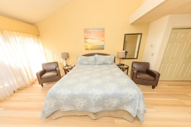 bedroom with hardwood / wood-style flooring and vaulted ceiling