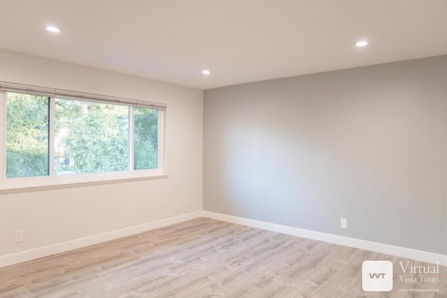 spare room with light hardwood / wood-style floors