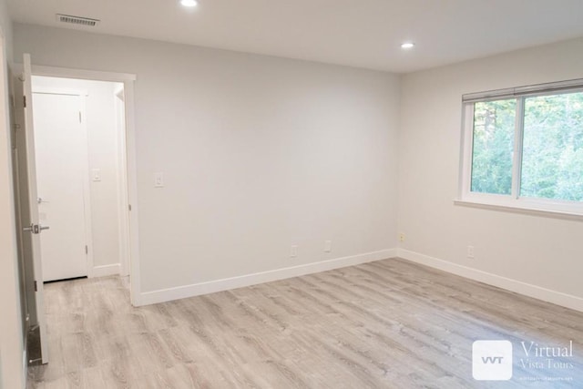 empty room with light hardwood / wood-style flooring