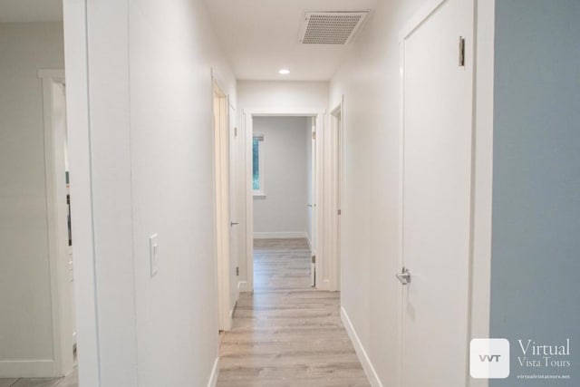 corridor with light hardwood / wood-style floors