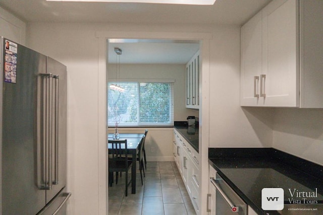 kitchen with white cabinetry, high quality fridge, light tile patterned floors, and dishwashing machine