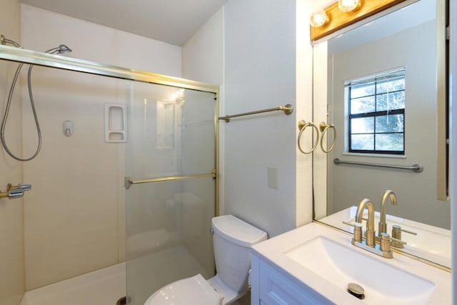 bathroom featuring vanity, toilet, and walk in shower