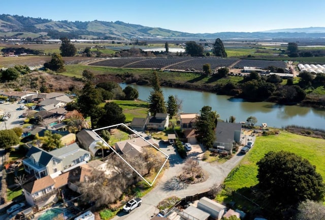 drone / aerial view featuring a water and mountain view