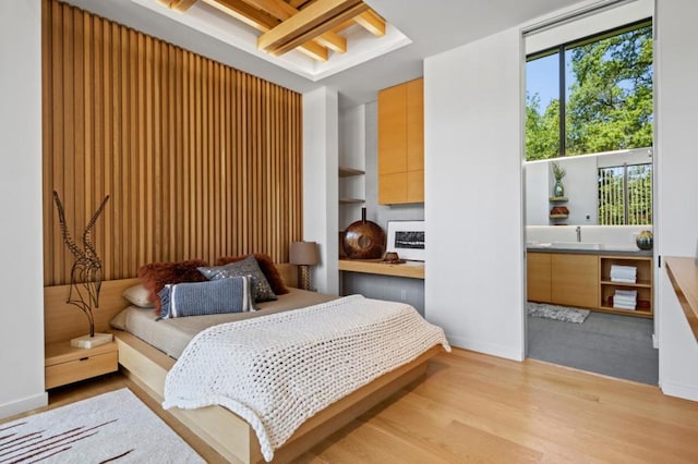 bedroom featuring sink and light wood-type flooring