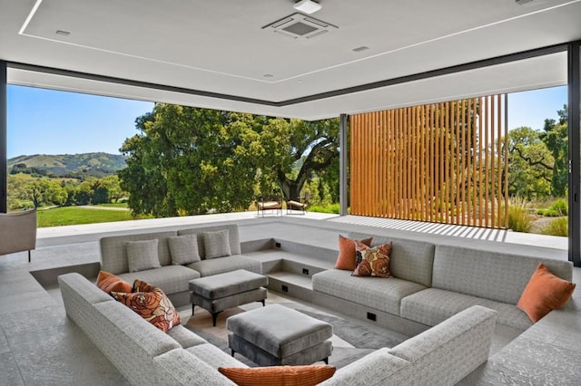 sunroom / solarium featuring a mountain view and a wealth of natural light