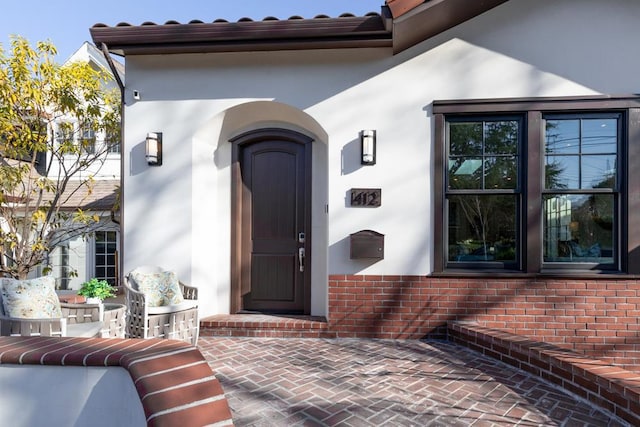 property entrance with a patio area