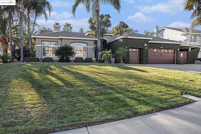 view of front of home with a garage and a front yard