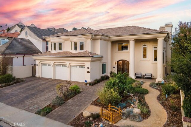 mediterranean / spanish house featuring a garage