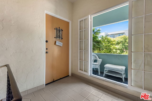 entryway featuring light tile patterned floors