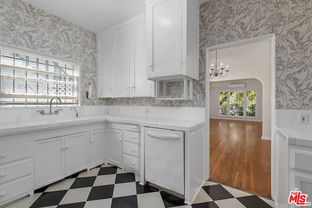 kitchen featuring white cabinetry, tile countertops, and dishwasher