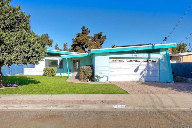 ranch-style home featuring a garage and a front yard