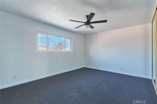 carpeted spare room featuring ceiling fan and a textured ceiling