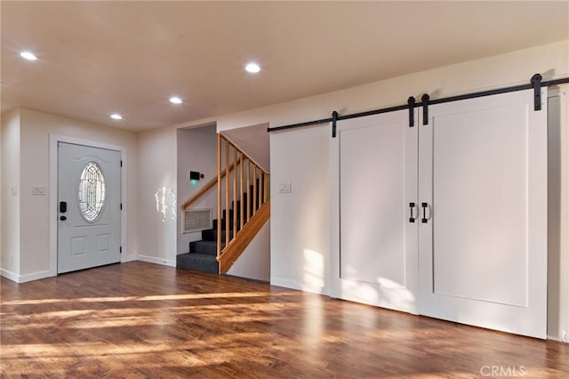 entrance foyer with dark hardwood / wood-style flooring and a barn door