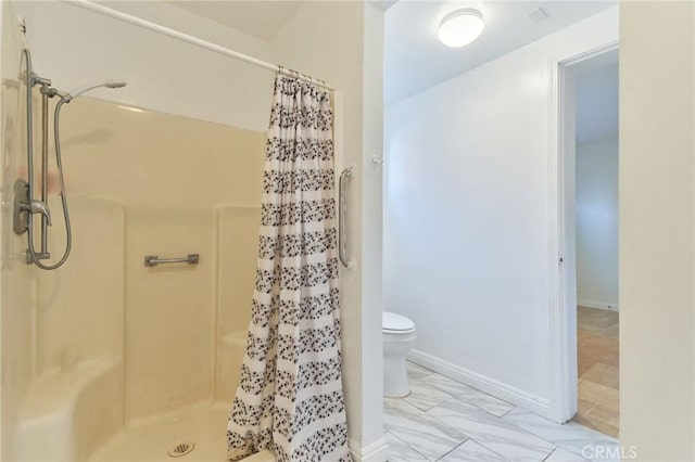 bathroom with toilet and walk in shower