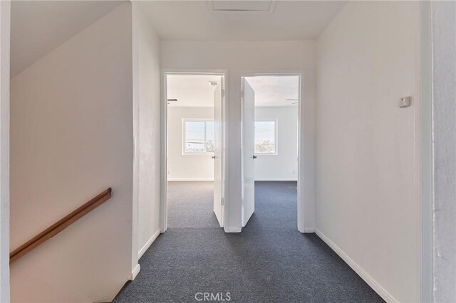 hallway with dark colored carpet