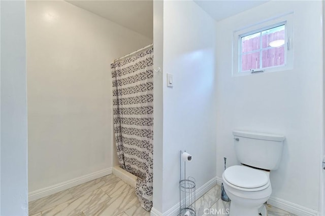 bathroom with toilet and a shower with shower curtain