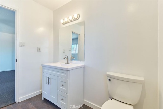 bathroom featuring hardwood / wood-style flooring, vanity, and toilet