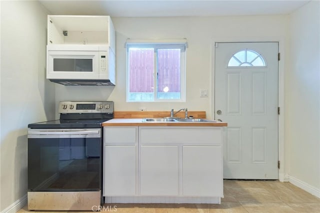 kitchen featuring white cabinetry, stainless steel electric stove, and sink